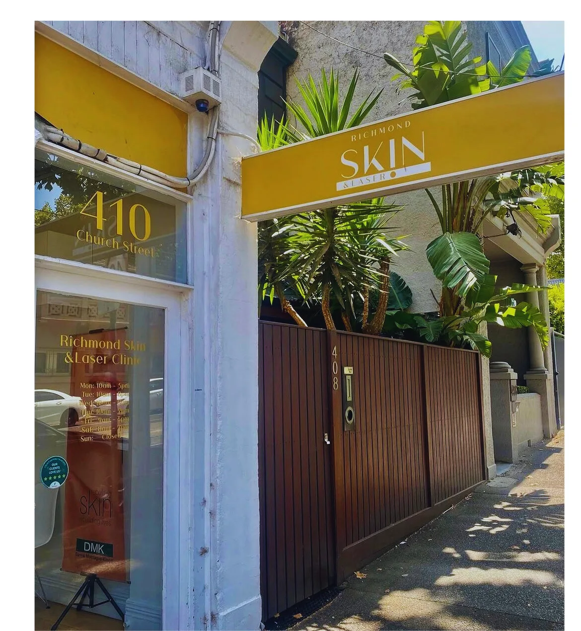 Richmond Skin & Laser Clinic shopfront at 410 Church Street, Richmond — marigold gold sign, tropical palms, boutique heritage facade